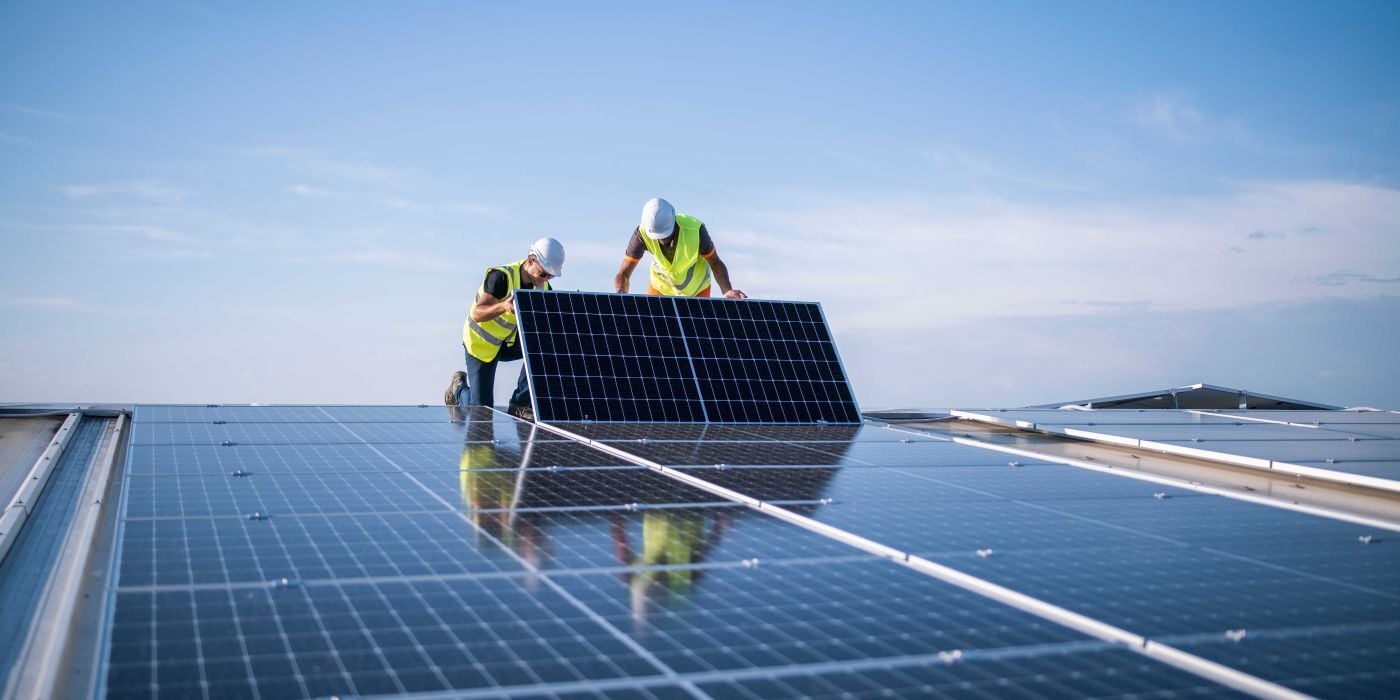 men working with solar panel