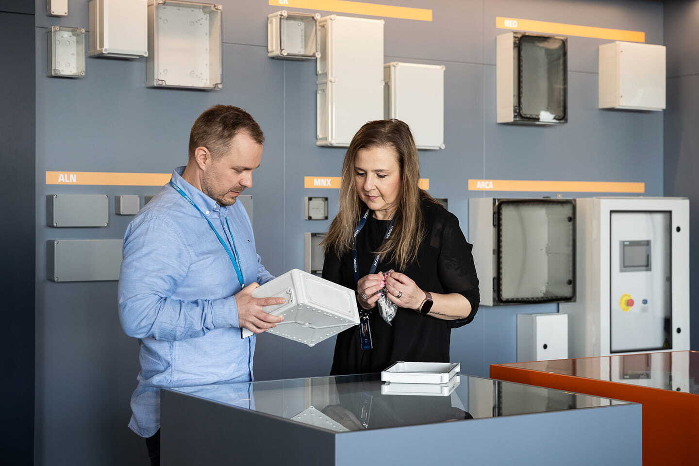 People looking at Fibox enclosures in showroom