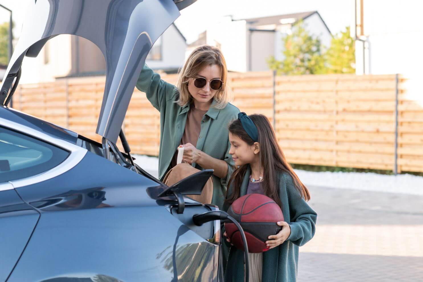 a mom and a daughter putting things in the car