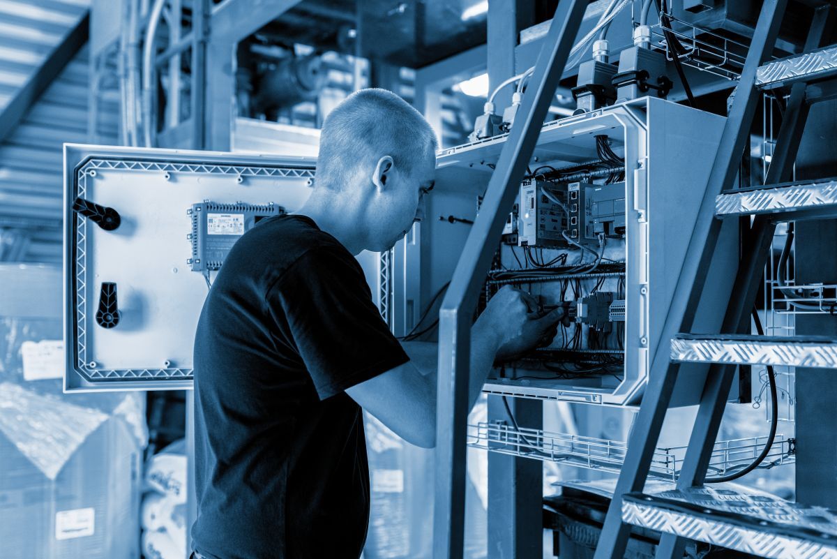 Man working with enclosure Man working with enclosure