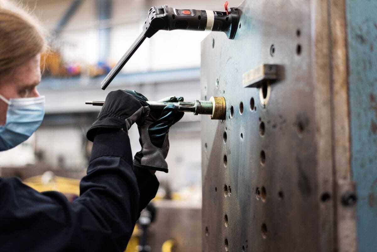 Man working with custom injection molding mold